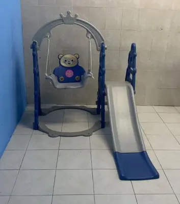 a teddy bear on a swing in a bathroom at MyLittle Homestay in Tanjung Malim