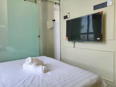 a hotel room with a bed with towels on it at Georgetown AY Hotel in George Town