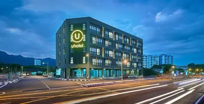 a building with a hotel sign on the side of a street at U Hotel Penang in Bayan Lepas