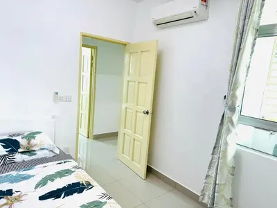 a bedroom with a bed and a window and a door at Spice Arena Service Apartment in Bayan Lepas