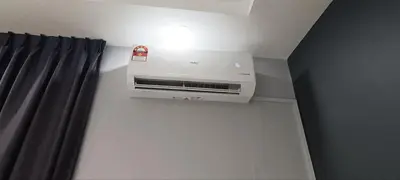 a air conditioner on a wall next to a curtain at Ipoh Garden East Homestay by Grab A Stay in Ipoh