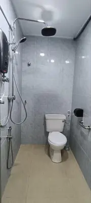 a bathroom with a toilet and a shower stall at Ipoh Garden East Homestay by Grab A Stay in Ipoh