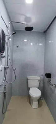 a small bathroom with a toilet and a shower at Ipoh Garden East Homestay by Grab A Stay in Ipoh