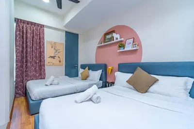 a room with two beds and a window at Tropicana 218 Macalister by YueLai Inn in George Town