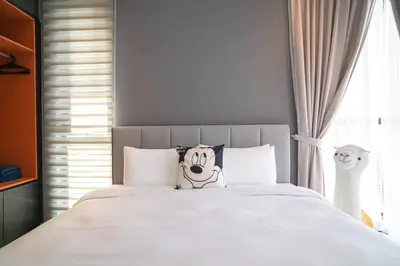 a bed with a pikachu pillow on top of it at Mickey's Magic Urban Suites Jelutong Penang, Seaview in Jelutong