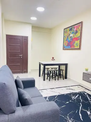 a living room with a couch and a table at Arena Spice Guesthouse in Bayan Lepas