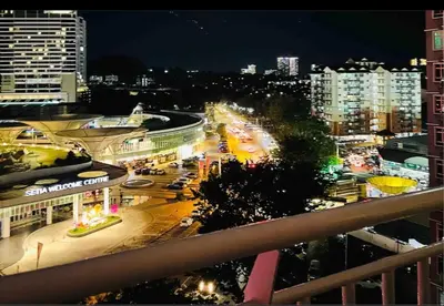 a view of a city at night with traffic at Arena Spice Guesthouse in Bayan Lepas