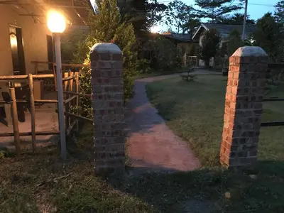 a set of three brick pillars in a yard at night at EFM GREENLAND IPOH in Ipoh