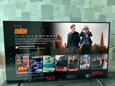 a television screen with a bunch of movies on it at D Festivo Residences Ipoh in Ipoh