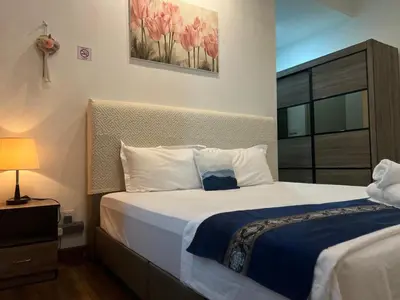 a bedroom with a large white bed and a window at D Festivo Residences Ipoh in Ipoh