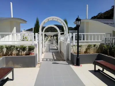 a walkway with an arch and a street light and benches at 1BR Cool Homestay at Cameron Golden Hills Night Market in Brinchang