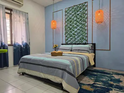 a bedroom with a bed and two orange lights at CASA AINA at Gopeng Cozy & Comfy Home in Kampong Kepayang