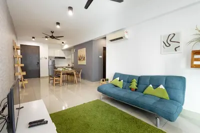 a living room with a blue couch and a dining room at Dream - Summer @Majestic Condo in Ipoh