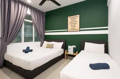 two beds in a room with green walls at Dream - Summer @Majestic Condo in Ipoh