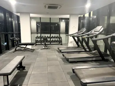 a gym with several treadmills and machines at Georgetown Classic Collection 3BR-10PAX in George Town