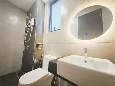 a bathroom with a sink and a toilet and a mirror at 3410 Home4Stay TownArea NewCozyHome InfinityPool in Jelutong