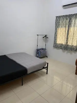 a bedroom with a bed in a room with a window at EmyNuar Homestay in Batu Kurau