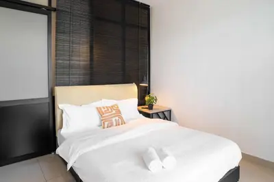 a bedroom with a white bed with two pillows at Chic - 4 bedroom - Projector - Ipoh Town - Sleep8 in Ipoh