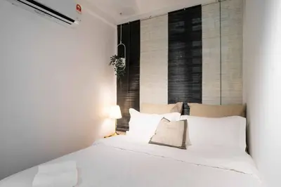 a white bed in a room with a window at Chic - 4 bedroom - Projector - Ipoh Town - Sleep8 in Ipoh