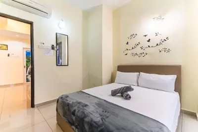 a bedroom with a bed with birds on the wall at Sea View Penthouse Comfy Home at Batu Ferringhi in Batu Ferringhi