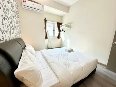 a bedroom with a white bed and a window at NAUTILUS HOME AT KARPAL SINGH For 14 PAX in George Town