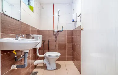 a bathroom with a toilet and a sink at Snooze Hotel in Brinchang