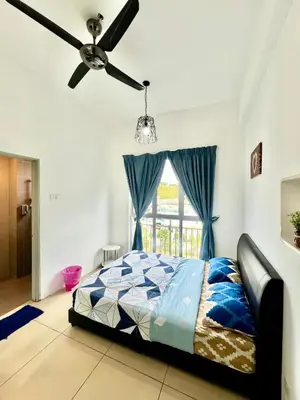 a bedroom with a bed and a ceiling fan at Peace Homestay in Cameron Highlands