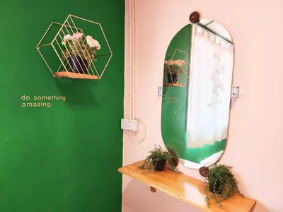 a mirror on a shelf next to a green wall at Ipoh Station 18, 4 Bedroom Rainforest LOFT 1 Depan AEON Homestay in Ipoh