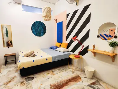 a bedroom with a bed and some art on the walls at Ipoh Station 18, Aeon Ipoh Rainforest 2 rooms LOFT 2 Homestay in Ipoh