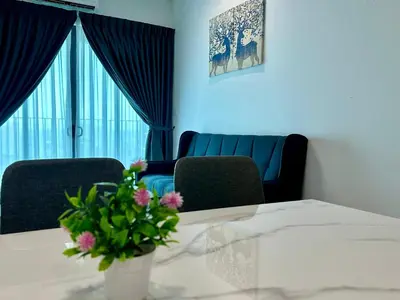 a room with a table with a vase with flowers on it at Suite BigStudio @Meritus Residensi in Perai