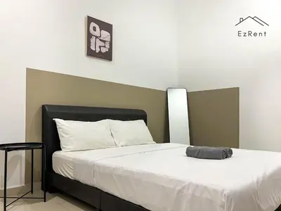 a bedroom with a bed with white sheets at Spacious Family 4BR House near Lake Garden Zoo Taiping with Free WiFi and Netflix in Taiping