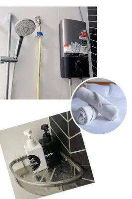 a bathroom with a sink and a towel dispenser at Yuru House - The Horizon Ipoh in Ipoh