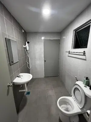 a bathroom with a toilet and a sink at Stay in Passionate in Sitiawan