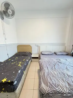 a bedroom with two beds and a fan at Azzalea's Apartment Ground Floor Cameron Highlands in Tanah Rata