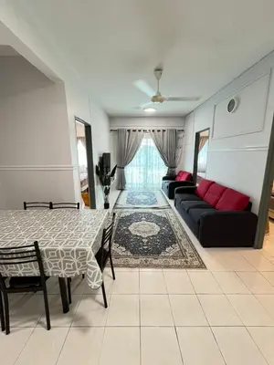 a living room with a table and a couch at Azzalea's Apartment Ground Floor Cameron Highlands in Tanah Rata