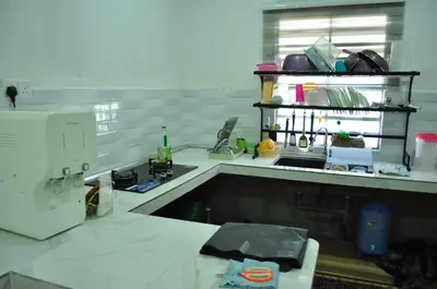a kitchen with a sink and a counter top at Uwais Homestay Segari Lumut in Lumut