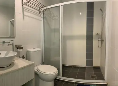 a bathroom with a shower and a toilet and a sink at Marina Island Seaview Homestay in Lumut