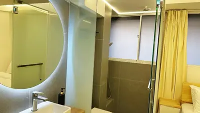 a bathroom with a shower and a sink and a mirror at Noordin ClanJetties Komtar Heritage Studio - E in George Town