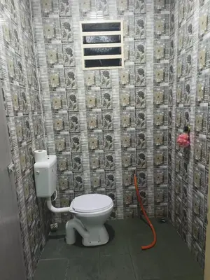 a bathroom with a toilet with a hose at KT’s Lake House in Ipoh