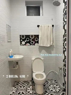 a bathroom with a toilet and a sink at ISLAMIC Pak Kop Homestay with private pool 2 in Parit Buntar