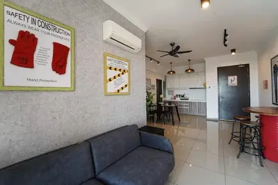 a living room with a couch and a kitchen at SIDE CONTRUCTION MODERN DESIGN@THE MAJESTIC IPOH in Ipoh