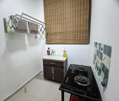 a small kitchen with a stove and a sink at IZZ Homestay MUSLiiM in Ipoh