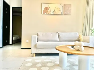 a living room with a couch and a table at Urban Suites #Creamy style #Infinity Pool #local neighbourhood #5pax #3BR 2bath #2Queen 1Single #Quality well maintained #Private host in Jelutong
