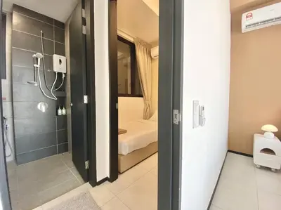 a bathroom with a shower and a bedroom with a shower at Urban Suites #Creamy style #Infinity Pool #local neighbourhood #5pax #3BR 2bath #2Queen 1Single #Quality well maintained #Private host in Jelutong