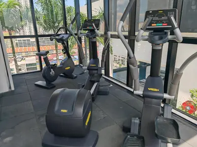 a row of exercise bikes in a gym at Modern Elegance - Urban Suites by Ocean Luxe in Jelutong