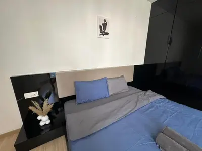 a bedroom with a bed with blue pillows at Luxury Suites 118 Island Plaza in Tanjong Tokong