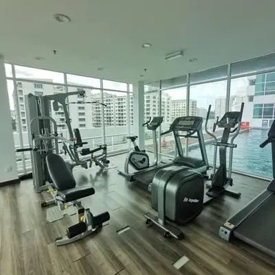 a gym with cardio equipment in a large building at Maritime Suite Penang - City & Sea view in George Town
