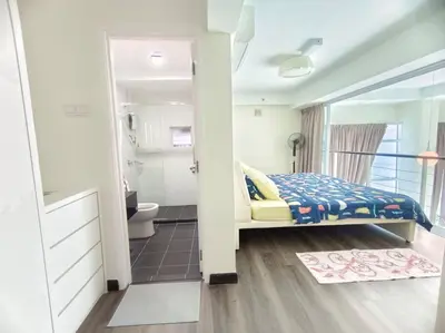 a bedroom with a bed and a bathroom at Maritime Suite Penang - City & Sea view in George Town