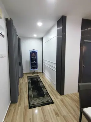 a hallway with a room with a door and a rug at The SilverCity Homestay Ipoh in Ipoh