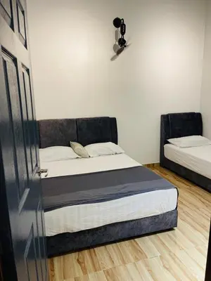 a bedroom with two beds in a room at The SilverCity Homestay Ipoh in Ipoh